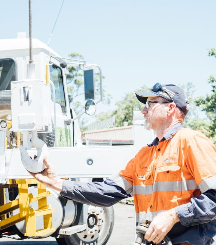 Employee Checking Crane Hook — Diesel Mechanic in Yandina, QLD