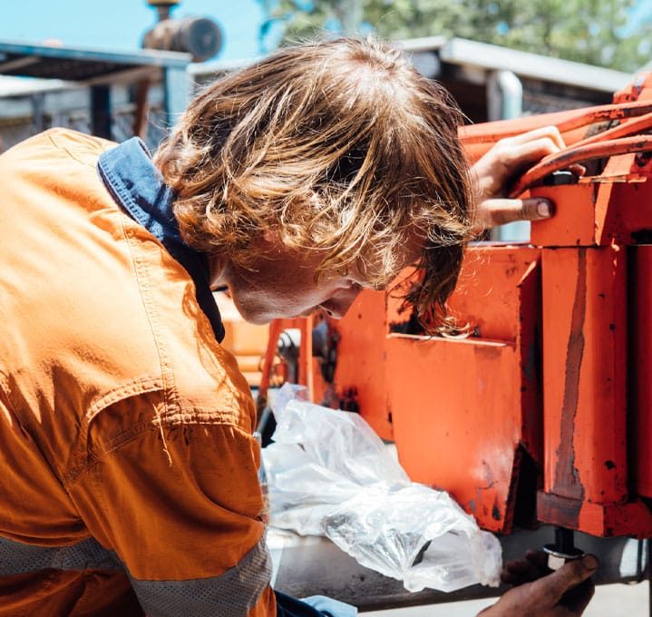 Mechanic Removing Oil Plug — Diesel Mechanic in Yandina, QLD